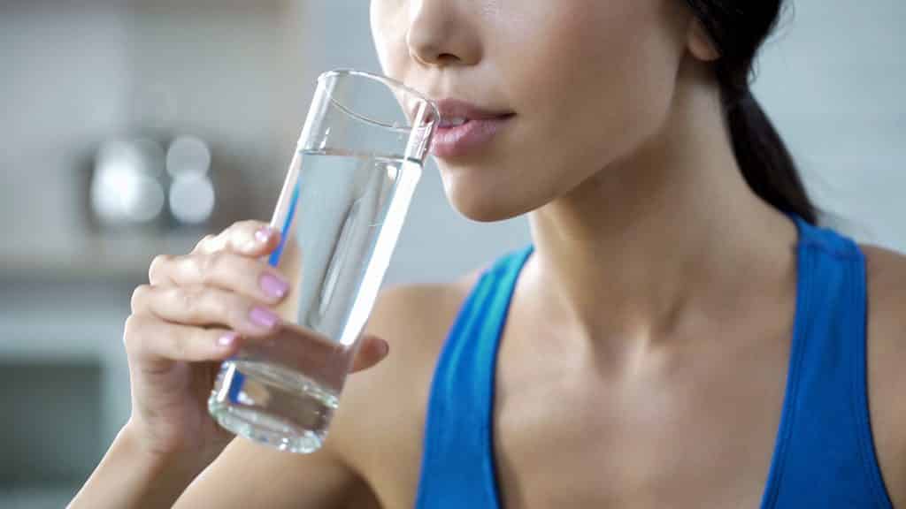 Sports girl drinking crystal clear water, restoring aqua balance after training, stock footage